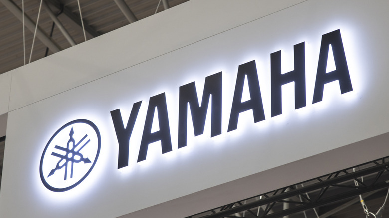 The Yamaha logo on a sign glowing.