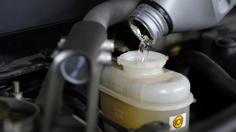 Brake fluid being added to car's brake reservoire.