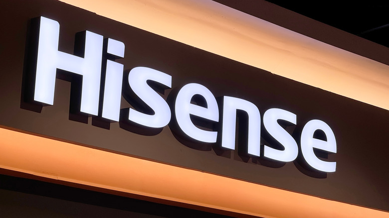 Illuminated Hisense brand signage displayed on top of a store