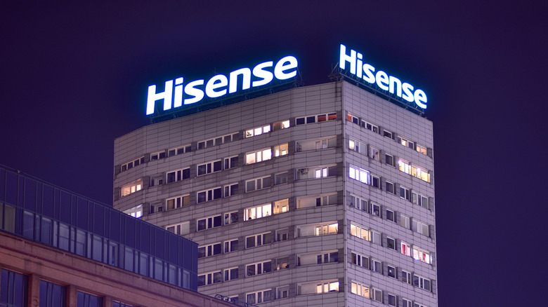 Two Hisense illuminated logos on top of a building