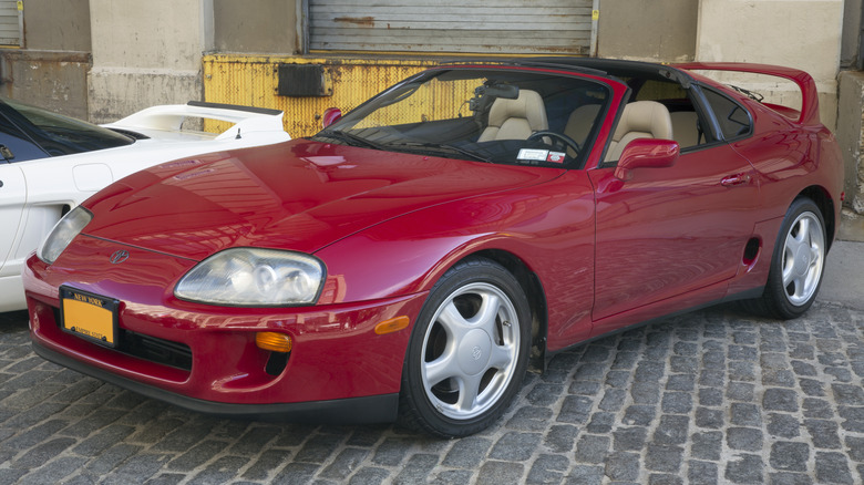 Red Toyota Supra MkIV on cobbles