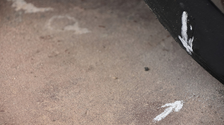 chalk marks on a tire and pavement