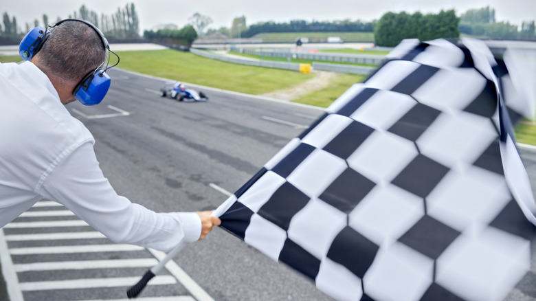 A race official waving the checkered flag