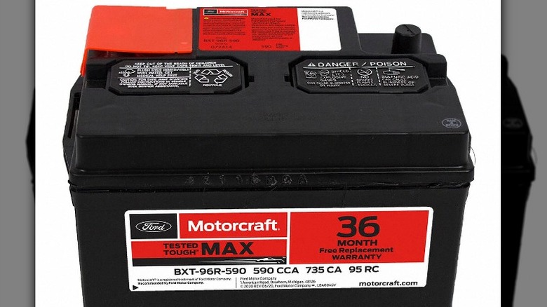 A red label on a black Motorcraft car battery from the Ford Motor Company.