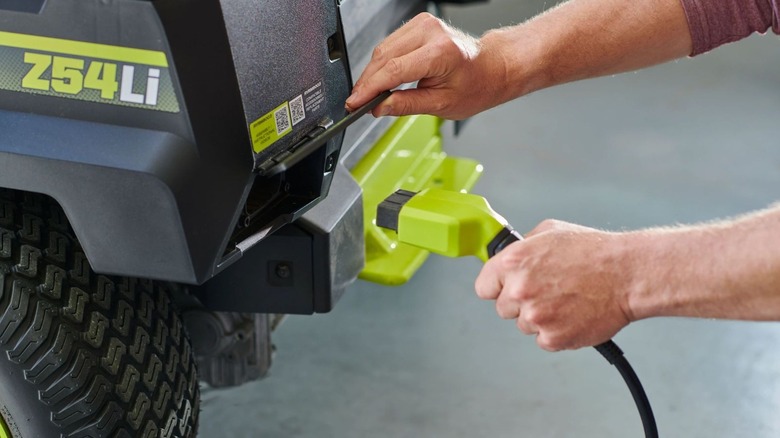 Ryobi 80V charger plugging into mower