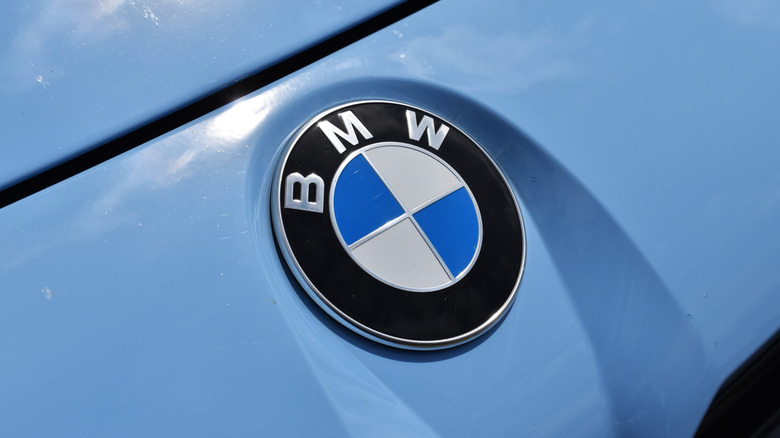 The BMW logo on a blue BMW vehicle.