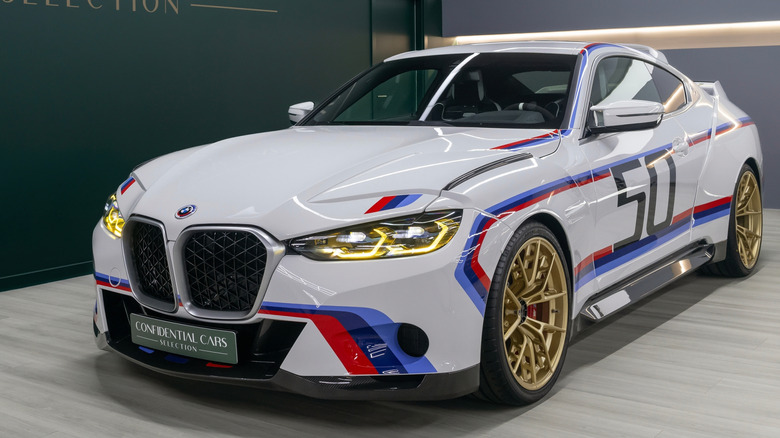 A BMW CSL 3.0 parked in a showroom.