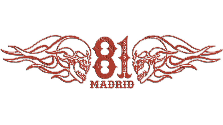 Two flaming skulls outlined in red facing each other across a "Support 81 Madrid" insignia on a white background.