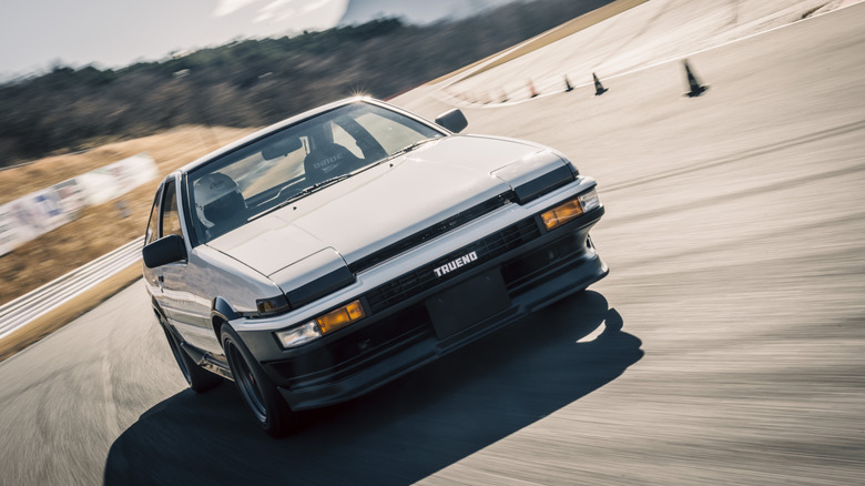 Toyota Corolla Sprinter Trueno (AE86) driving on race circuit, front view