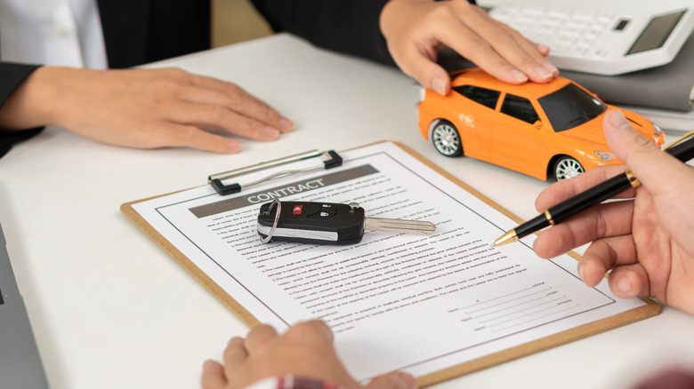 Car dealership signing contract