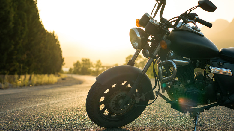 A motorcycle parked on the side of a curving road