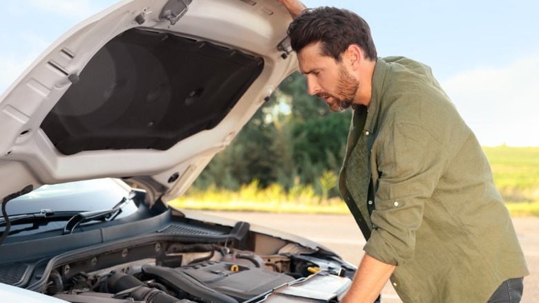 person looking at engine