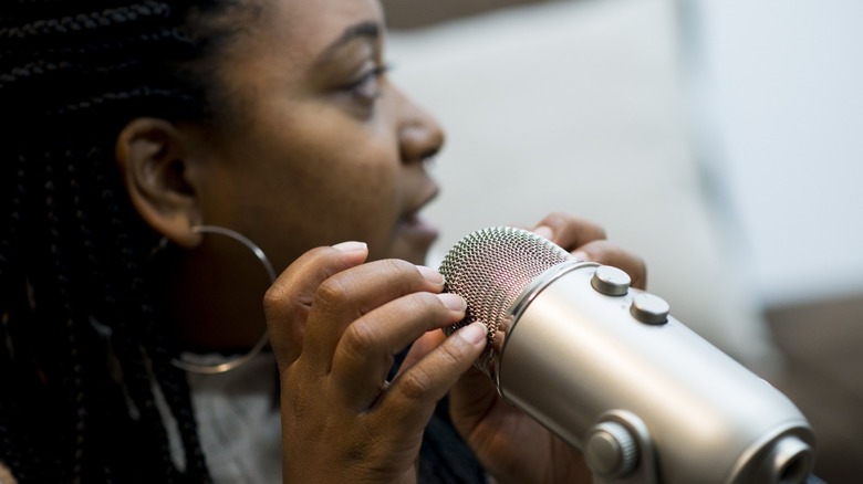 woman tapping on microphone