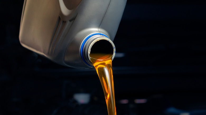 Oil being poured into an engine.