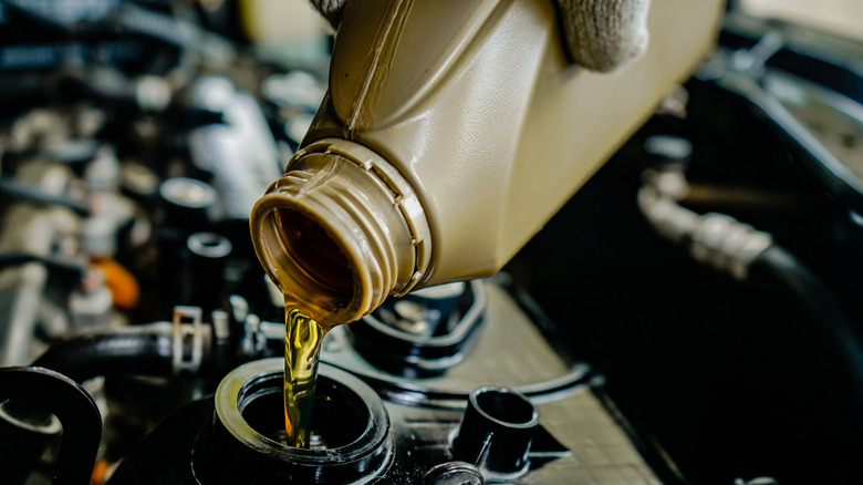 Close-up of changing engine oil in a car