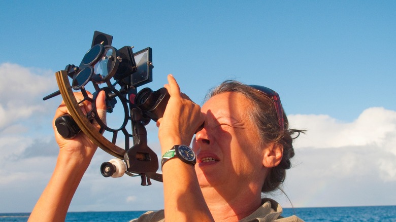 a person using a sextant