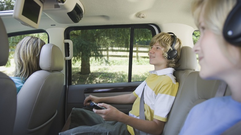 Kids using car TV in backseat