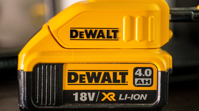 A DeWalt battery attached to a charger.