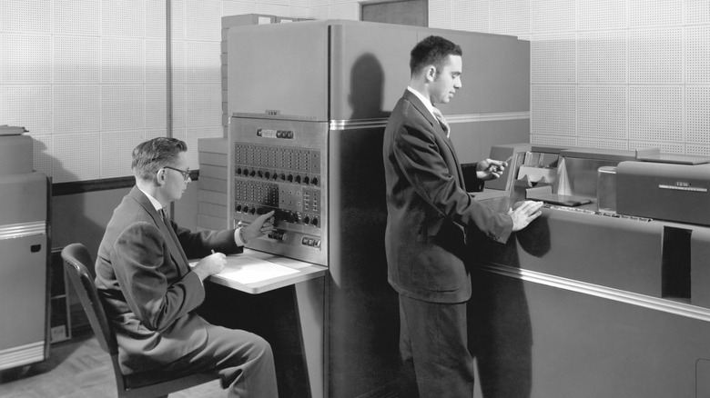 Two businessmen operating an IBM 650