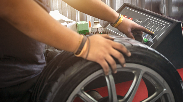 Technician balancing the wheel