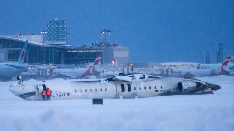 Delta flight 4819 lies buried in the snow at Toronto's Pearson International Airport