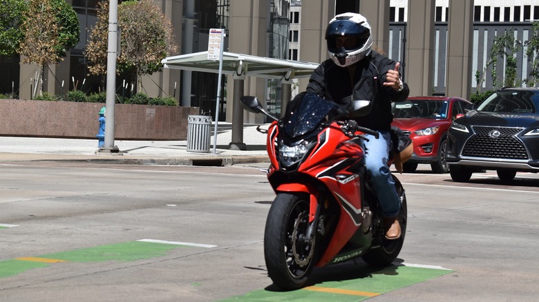 Motorcyclist gestures with one hand