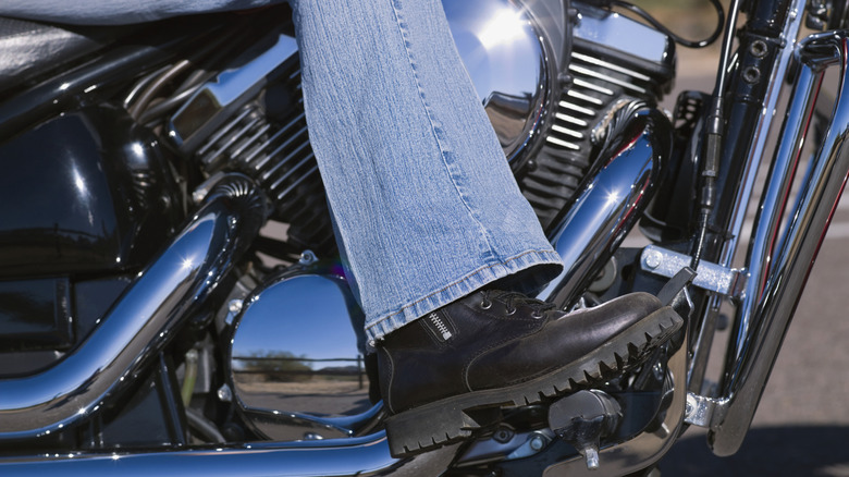 woman with boots on motorcycle