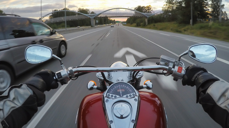 biker passing an SUV on highway