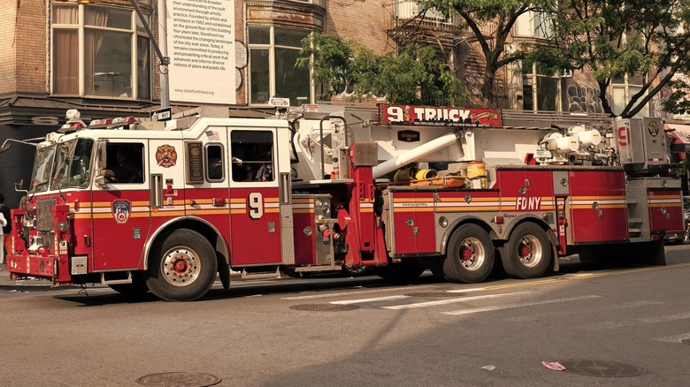 firetruck on city road, straddling zebra crossing