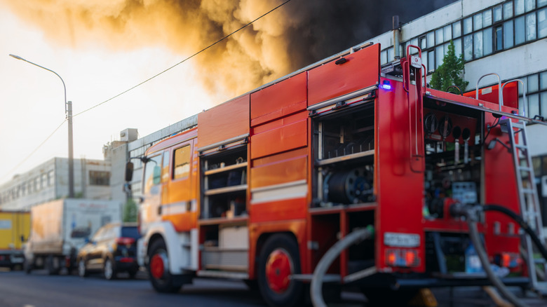 Fire truck putting out fire in building