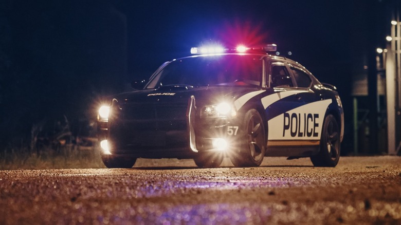 Police car with flashing lights.