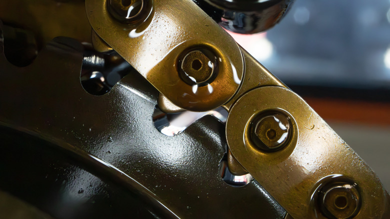 Close-up of car gearbox chain with oil drop on it. Transfer case