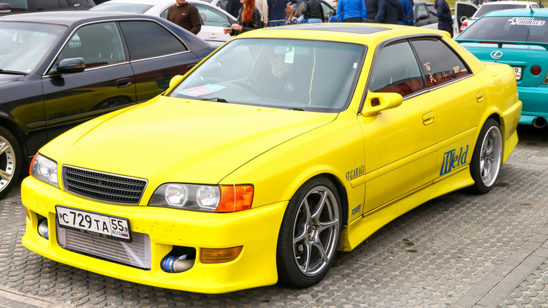 Yellow Toyota Chaser parked at outdoor car show