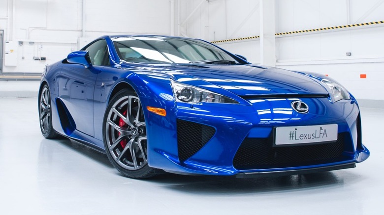 a blue Lexus LFA in large open room