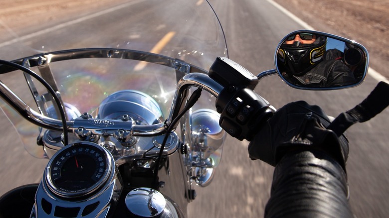 Close-up of biker's hand on Harley-Davidson handlebars