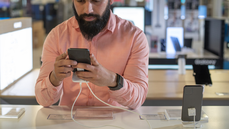 man testing phone at store