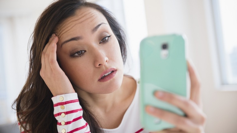 Frustrated woman using a phone