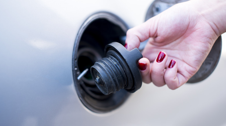 Person removing gas cap