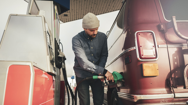 Man pumping gas into van