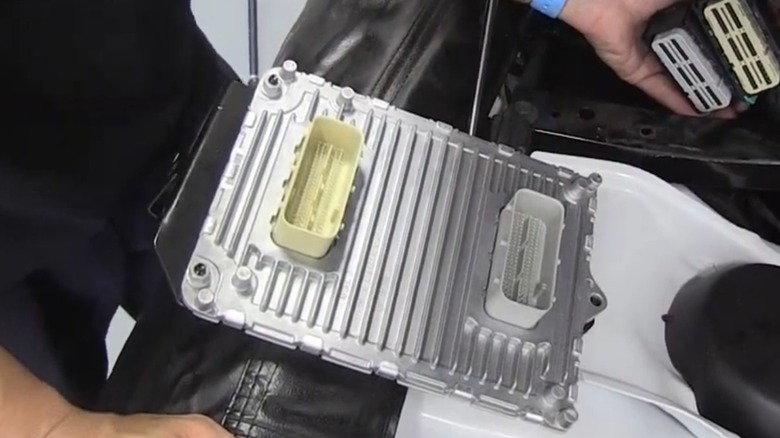 an automotive pcm pulled out of a dodge charger