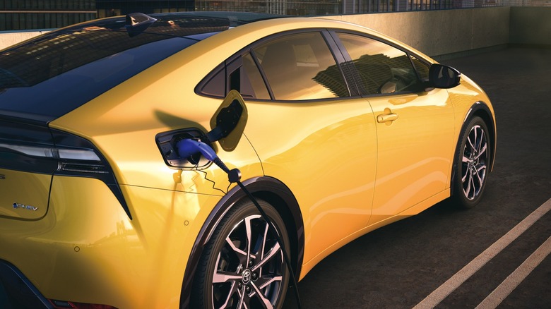 a yellow Toyota Prius PHEV charging