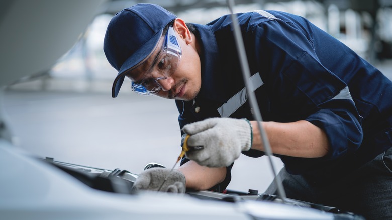 Mechanic checking automobile engine