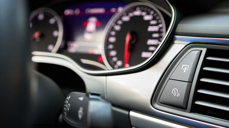 A blurry image of a car's instrument cluster and center air con vents