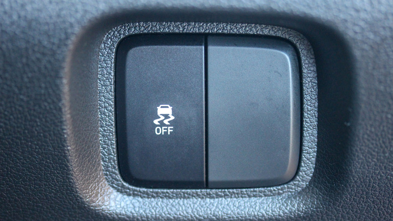 A close-up shot of the traction control button and a blank button