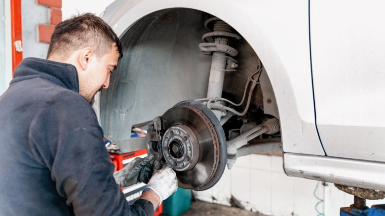 mechanic replacing brakes