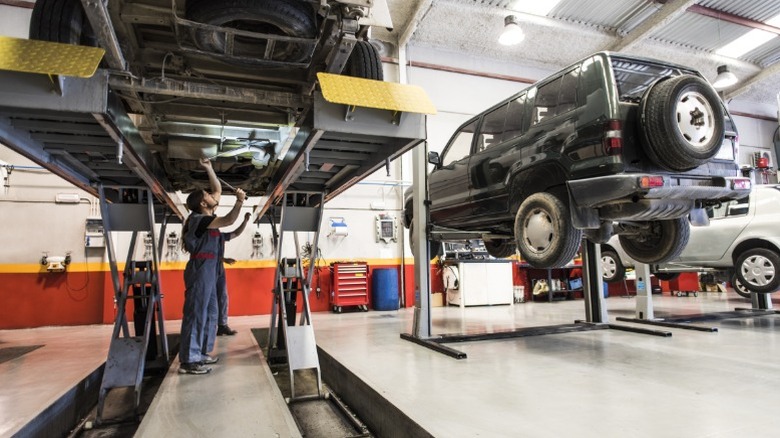 A mechanic checks a car