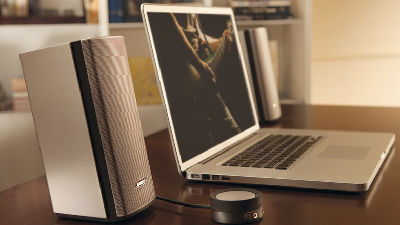 Bose speaker next to a laptop