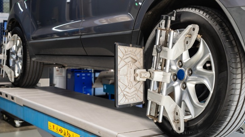 A closeup image of a car on an alignment rack for an alignment check