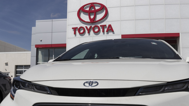 Toyota Corolla in front of dealership