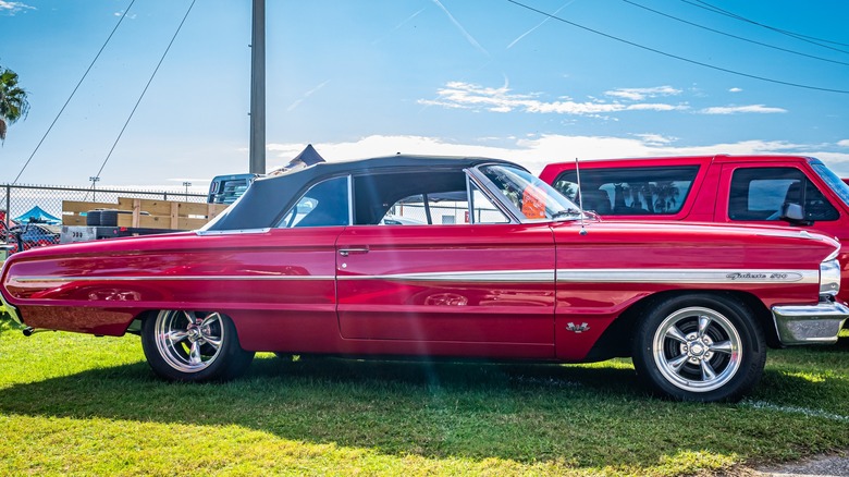 Red 1964 Ford Galaxie 500 convertible at a carshow
